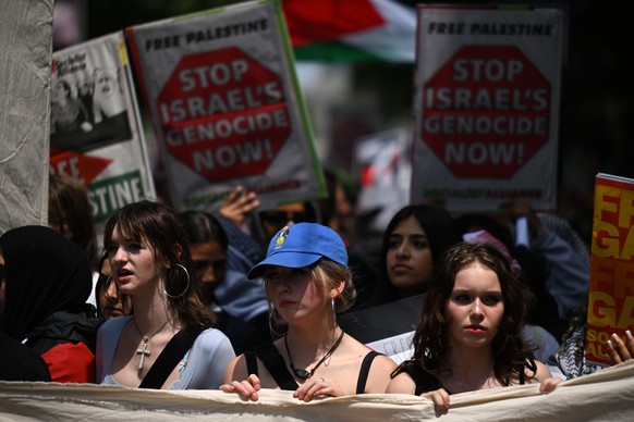 epa10990389 People participate in a pro-Palestinian demonstration in Melbourne, Australia, 23 November 2023. Thousands of Israelis and Palestinians have died since the militant group Hamas launched an ...