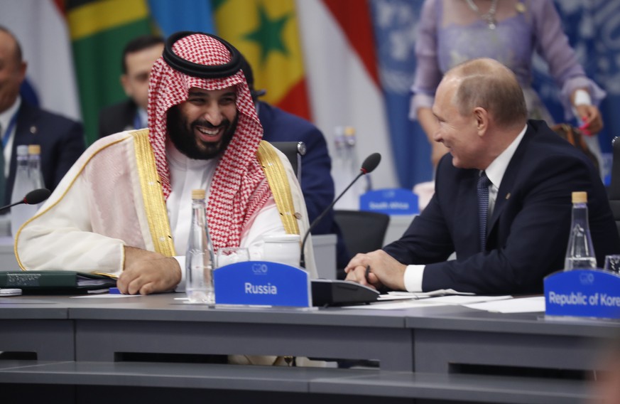 Saudi Arabia Crown Prince Mohammed bin Salman talks with Russia President Vladimir Putin during a G20 session with other heads of state, Friday, Nov. 30, 2018 in Buenos Aires, Argentina. (AP Photo/Pab ...