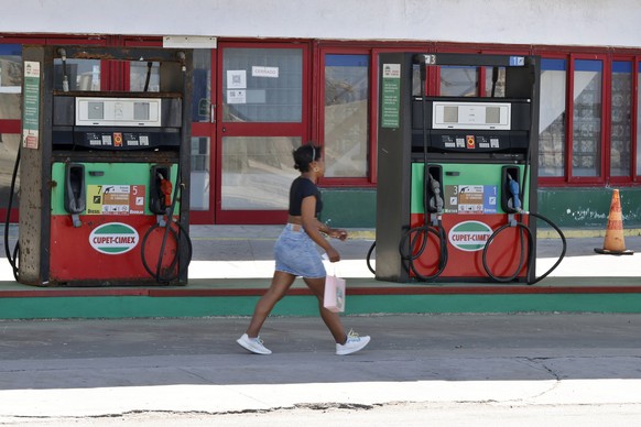epaselect epa12859110 A person walks past a gas station in Havana, Cuba, 27 March 2026 (issued 29 March 2026). Cuba has been without 'a drop of fuel' for three months due to the US oil embar ...