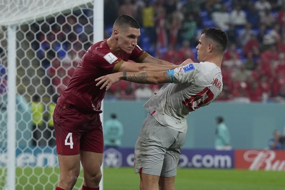 Serbia&#039;s Nikola Milenkovic, left, pushes Switzerland&#039;s Granit Xhaka during the World Cup group G soccer match between Serbia and Switzerland, in Doha, Qatar, Friday Dec. 2, 2022. (AP Photo/R ...