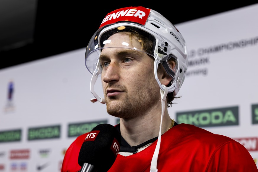 Switzerland's defender Janis Jerome Moser speaks with media in the mixed zone of the Jyske Bank Boxen after a Switzerland team training session, at the IIHF 2025 World Championship, in Herning, D ...