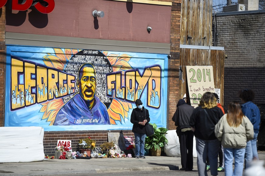 epa09105503 After nearly a year, a memorial to George Floyd still gathers onlookers outside of Cup Foods, the site where Floyd died in police custody, in Minneapolis, Minnesota, USA, 29 March 2021. Op ...