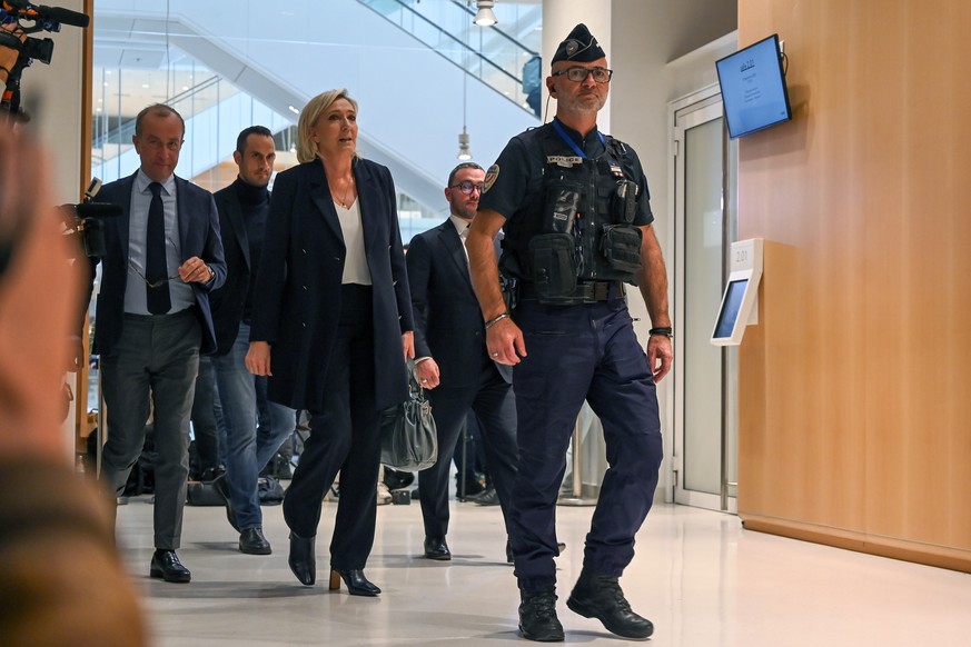 epa11633887 French far-right party leader Marine Le Pen leaves the court after the first day of trial over alleged embezzlement of public funds and collusion, at the Paris courthouse in Paris, France, ...