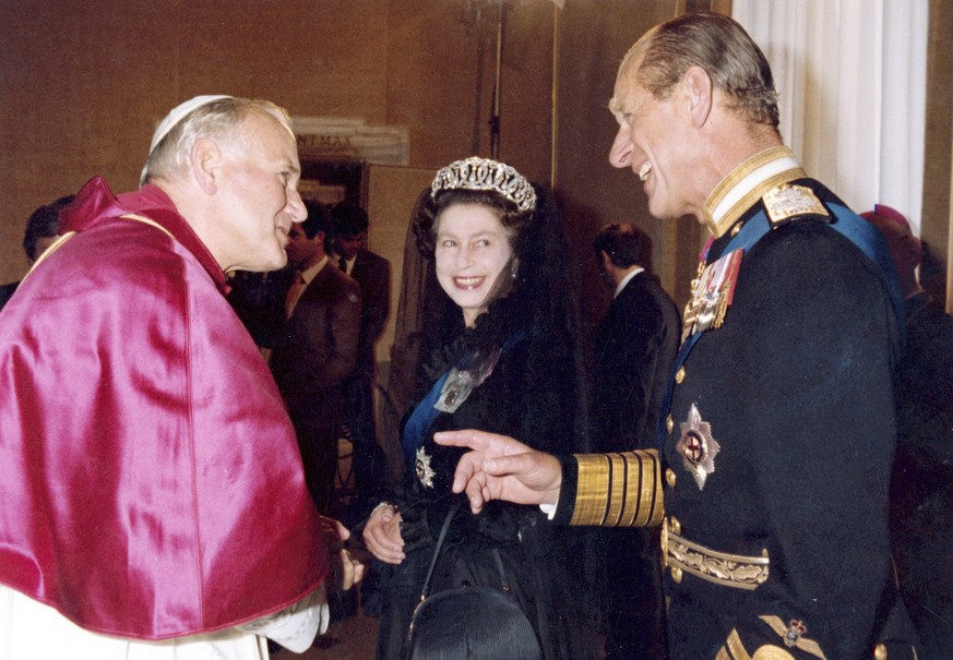 FILE - In this Oct. 17, 1980 file photo, Britain's Queen Elizabeth II, smiles at her husband Prince Philip, during an audience with Pope John Paul II in his private study at the Vatican, Italy. B ...