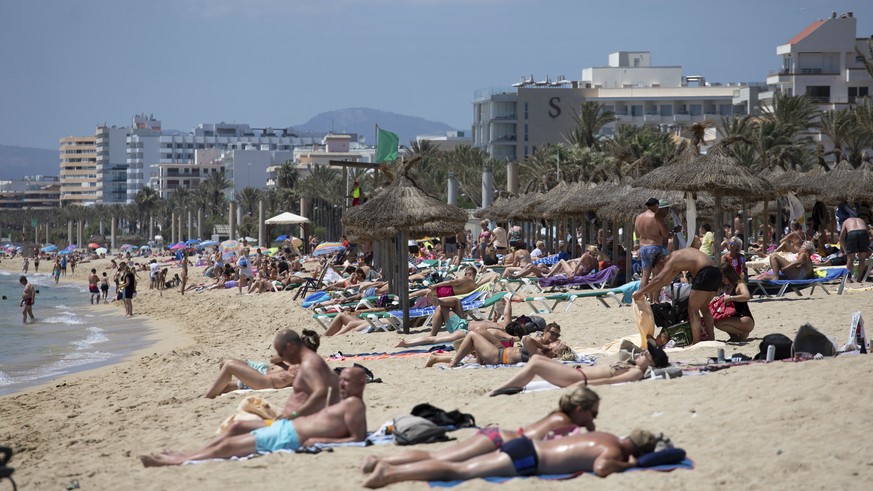 Tourists sunbathe on the beach at the Spanish Balearic Island of Mallorca, Spain, Monday, June 7, 2021. Spain is jumpstarting its summer tourism season by welcoming vaccinated visitors from most count ...