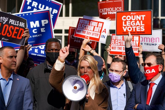 PHILADELPHIA, PA - NOVEMBER 5: Corey Lewandowski, left, and Pam Bondi speak to protestors, announcing that vote counting had halted and a judges order to allow observers within six feet of counting, o ...