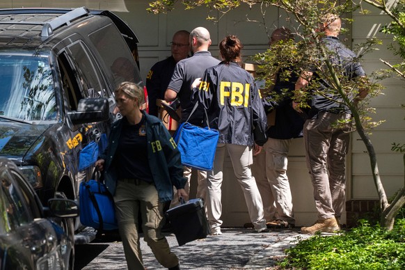 FBI agents carry bags and boxes out of former national security adviser John Bolton&#039;s house Friday, Aug. 22, 2025, in Bethesda, Md. (AP Photo/Manuel Balce Ceneta)
Trump FBI Bolton