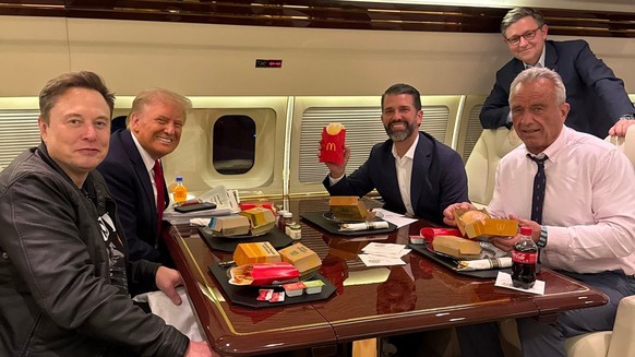 RFK Jr, à droite, futur ministre de la Santé, sur le point d’avaler un Big Mac à bord de Trump Force One, quelques jours après l’élection.