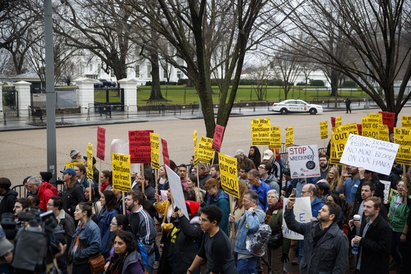 epa08102770 Demonstrators march from the White House to the Trump International Hotel to protest US military involvement in the Middle East in Washington, DC, USA, 04 January 2020. The Pentagon deploy ...