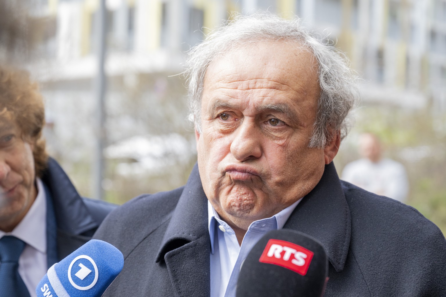 epa11986795 Former UEFA President, Michel Platini speaks to journalists after the verdict at the special appeals court, in Muttenz, Switzerland, 25 March 2025. A special appeals court, sitting in Mutt ...