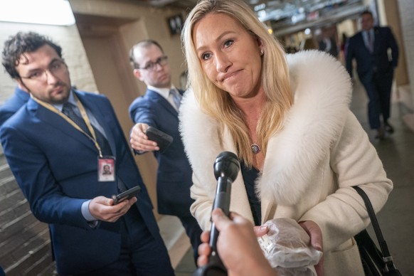 epa10441355 Republican Representative from Georgia Marjorie Taylor Greene (R) responds to a question from the news media as she departs from a Republican caucus meeting in the US Capitol in Washington ...
