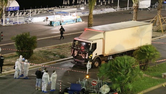 Authorities investigate a truck after it plowed through Bastille Day revelers in the French resort city of Nice, France, Thursday, July 14, 2016. France was ravaged by its third attack in two years wh ...