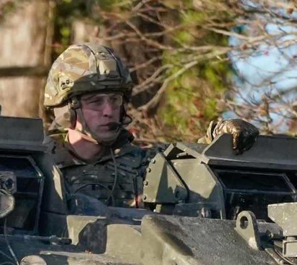 SALISBURY, ENGLAND - NOVEMBER 23: Prince William, Prince of Wales, Colonel-in-Chief, 1st Battalion Mercian Regiment (L) listens to a briefing ahead of an attack exercise during a visit to the regiment ...
