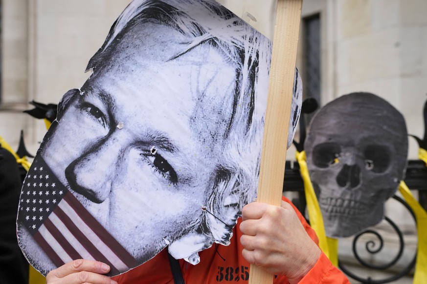 A demonstrator holds a Julian Assange mask outside the Royal Courts of Justice in London, Tuesday, Feb. 20, 2024. Julian Assange?s lawyers will begin their final U.K. legal challenge to stop the WikiL ...