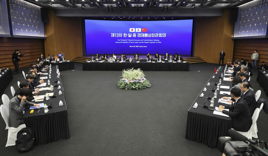 Delegation of South Korea, center, China and Japan, left, attend the 13th Trilateral Economic and Trade Ministers&#039; Meeting to discuss economic cooperation in Seoul, South Korea, Sunday, March 30, ...
