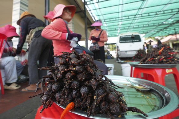Cambodian vendors sell deep-fried spiders at the town of Skun, northeast of Phnom Penh, Cambodia, Friday, Feb. 7, 2025. ( AP Photo/Heng Sinith)
