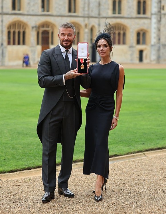 WINDSOR, ENGLAND - NOVEMBER 4: Sir David Beckham poses with wife Victoria after receiving his knighthood for services to sport and charity at Windsor Castle on November 4, 2025 in Windsor, England. (P ...