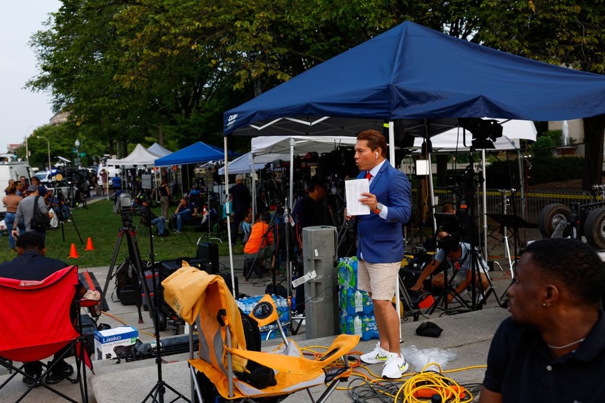 WASHINGTON, DC - AUGUST 03: TV journalists work in front of the E. Barrett Prettyman United States Courthouse on August 3, 2023 in Washington, DC. Former U.S. President Donald Trump is scheduled to be ...