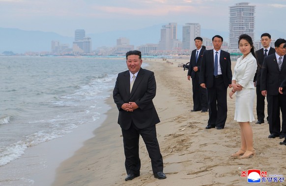 epa12197959 A photo released by the official North Korean Central News Agency (KCNA) shows North Korean leader Kim Jong Un (L) and his daughter Kim Ju Ae (3-R) standing on a beach during a ceremony ma ...
