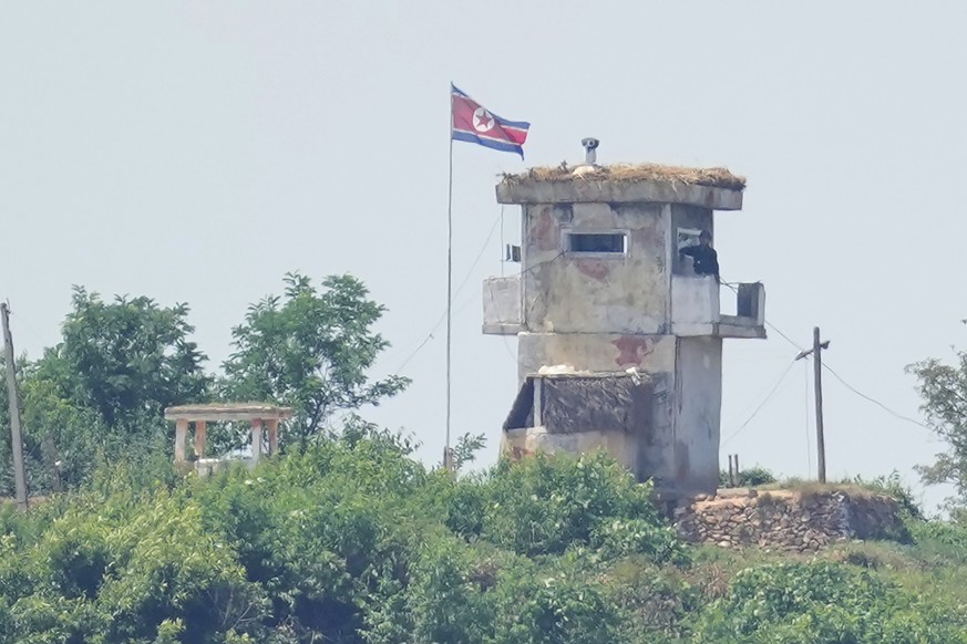FILE - A soldier stands at a North Korean military guard post flying a national flag, seen from Paju, South Korea, on June 26, 2024. (AP Photo/Lee Jin-man, File)