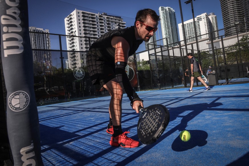 A person plays padel on a court in Miami, Florida, on March 22, 2026. Padel, the racket sport that originated among the elites of Latin America and Spain, has exploded in popularity in Miami. Fans say ...
