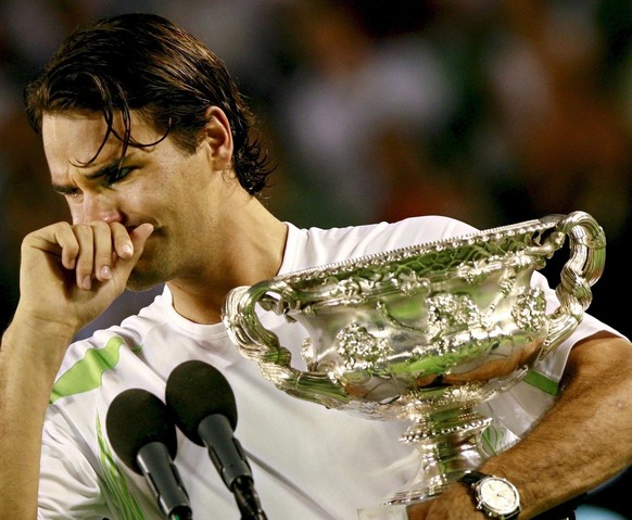 Roger Federer of Switzerland cries while holding his Australian Open Championship trophy after defeating Marcos Baghdatis from Cyprus in the finals match at the Australian Open tennis tournament in Me ...