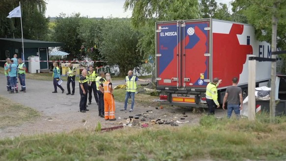 In this frame grab taken from video, policemen and rescuers stand at the site where a truck plowed into a gathering in the village of Nieuw-Beijerland, Netherlands, Saturday Aug. 27, 2022. A truck dro ...