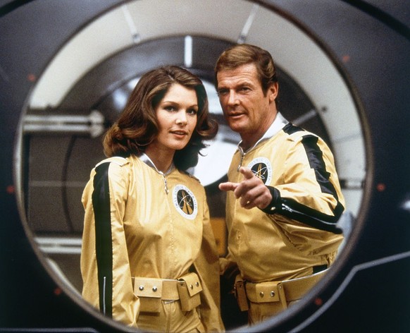 Actor Roger Moore and actress Lois Chiles on the set of "Moonraker". (Photo by Sunset Boulevard/Corbis via Getty Images)