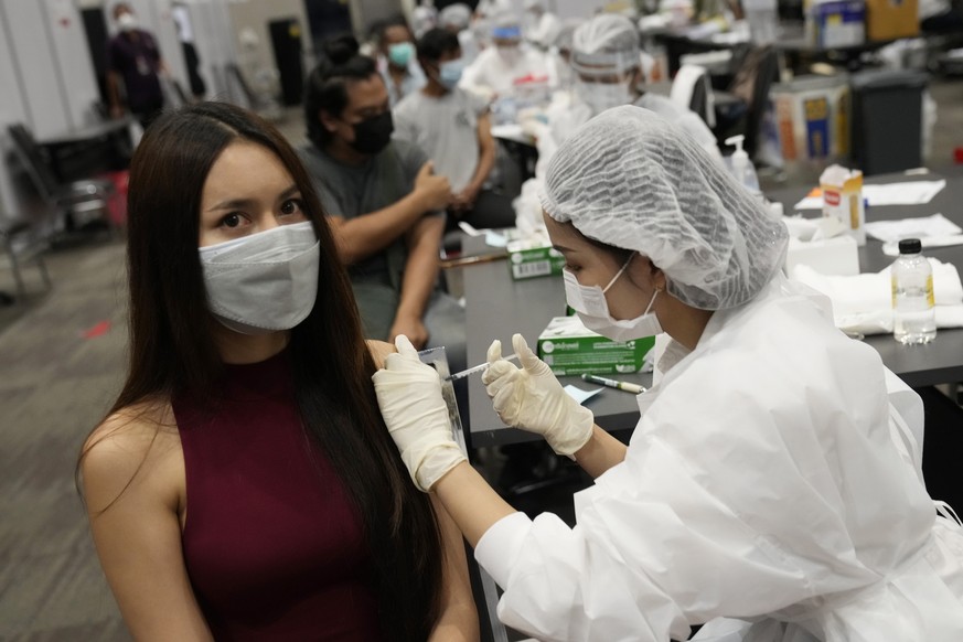 A health worker administers a dose of the AstraZeneca COVID-19 vaccine to a woman in Bangkok, Thailand, Friday, Aug. 20, 2021. Thailand has recorded more than 1 million accumulated cases on Friday sin ...