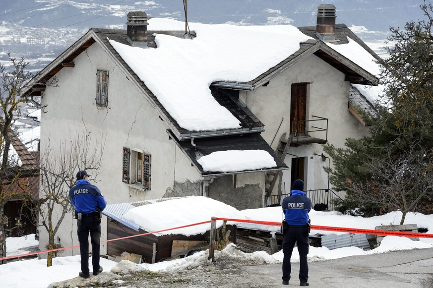Policemen investigate the house of the gunman and the shooting scene after a shooting in Daillon, Switzerland, Thursday, January 3, 2013. Late Wednesday, January 2, a gunman opened fire in the street  ...