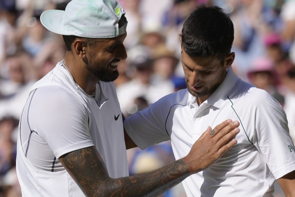 Serbia&#039;s Novak Djokovic, right, celebrates beating Australia&#039;s Nick Kyrgios in the final of the men&#039;s singles on day fourteen of the Wimbledon tennis championships in London, Sunday, Ju ...