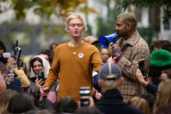 LONDON, ENGLAND - NOVEMBER 09: An entrant in a Harry Styles lookalike competition is cheered by fans of the former One Direction singer during a round of judging at Soho Square on November 09, 2024 in ...
