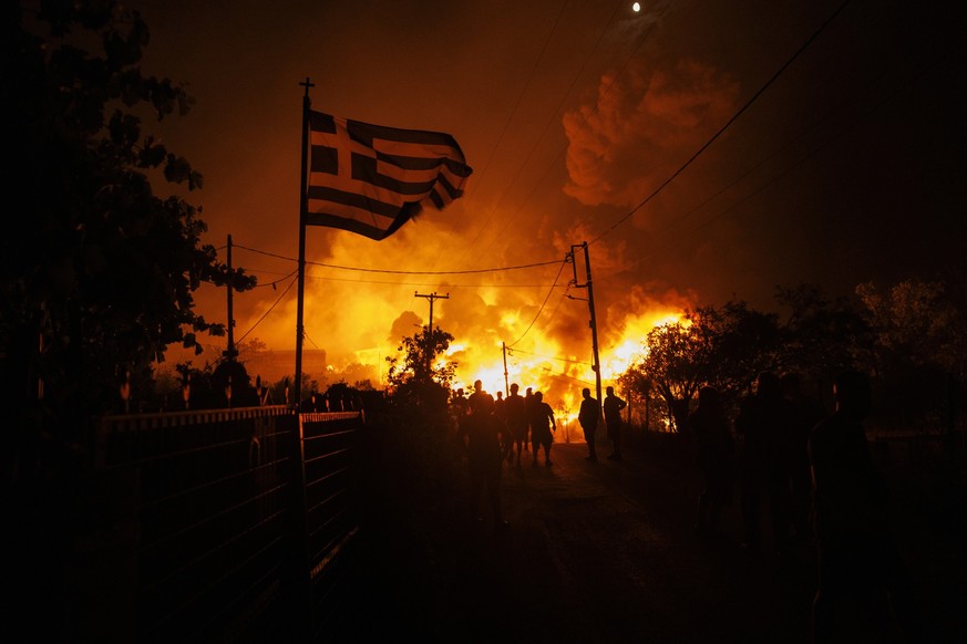 epa13088241 Firefighters and volunteers battle a wildfire in Oreokastro, near Thessaloniki, Greece, 05 July 2026.The wildfire set several businesses on fire and prompted evacuations in nearby settleme ...