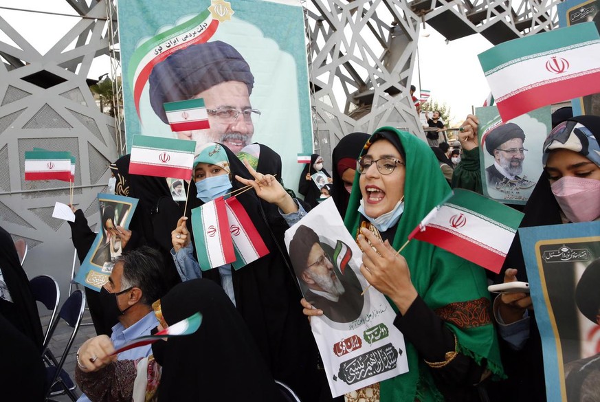 epaselect epa09286124 Supporters of Iranian president elect Ebrahim Raisi celebrate in Imam Hussein square in Tehran, Iran, 19 June 2021. According to an interior ministry official, Raisi with 17.9 mi ...
