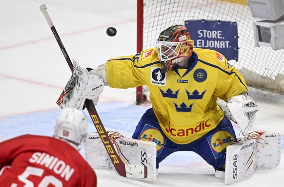 Goalkeeper Joel Lassinantti of Sweden in action against Dario Simion of Switzerland during the ice hockey Euro Hockey Tour EHT Karjala Cup match between Sweden and Switzerland in Turku, Finland, Novem ...