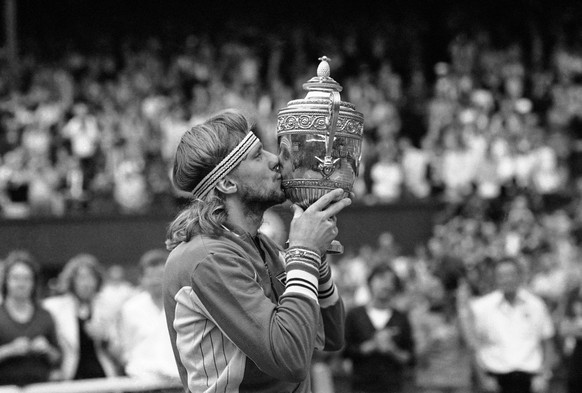 Sweden&#039;s Bjorn Borg kisses his trophy, after defeating John McEnroe in the final of the Men&#039;s Singles Championship at Wimbledon in England, July 5, 1980. Borg defeated McEnroe 1-6; 6-3; 7-5; ...