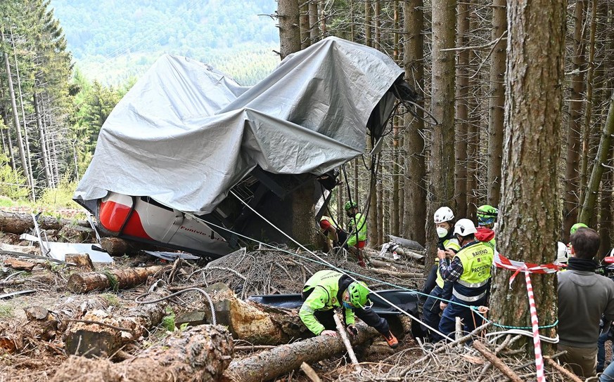 epa09228998 Carabinieri and Soccorso Alpino forces inspect the site where the Stresa-Alpino��&amp;#x201c;Mottarone cable car crashed to the ground after a cable snapped on 23 May 2021, in Mottarone St ...