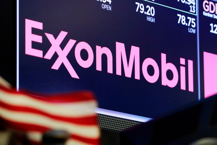 FILE - The logo for ExxonMobil appears above a trading post on the floor of the New York Stock Exchange, April 23, 2018. ExxonMobil says it is boosting its spending on greenhouse gas emission-reductio ...