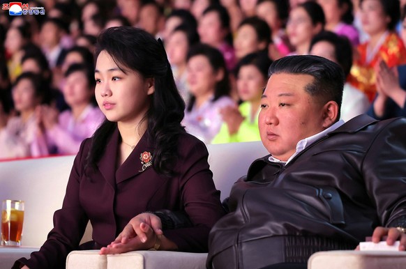 In this photo provided Monday, March 9, 2026, by the North Korean government, its leader Kim Jong Un, right and his daughter attend a concert which marks the International Women's Day in Pyongyan ...