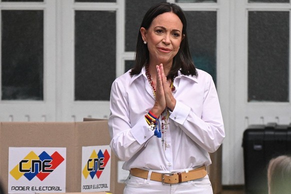 (FILES) Venezuelan opposition leader Maria Corina Machado gestures as she votes during the presidential election, in Caracas on July 28, 2024. Venezuela opposition leader Maria Corina Machado wins the ...