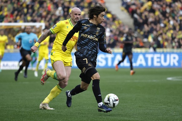 Reims&#039; Junya Ito, right, challenges for the ball with Nantes&#039; Nicolas Pallois during the French League One soccer match between Nantes and Reims at the Stade de la Beaujoire stadium in Nante ...