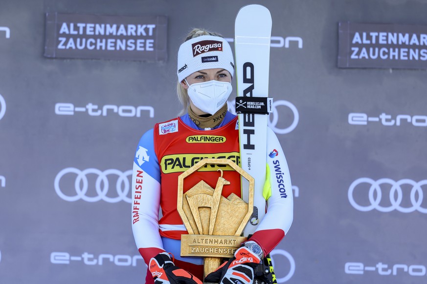 Switzerland's Lara Gut Behrami celebrates on the podium after winning an alpine ski, women's World Cup downhill race, in Zauchensee, Austria, Saturday, Jan. 15, 2022. (AP Photo/Marco Trovati ...
