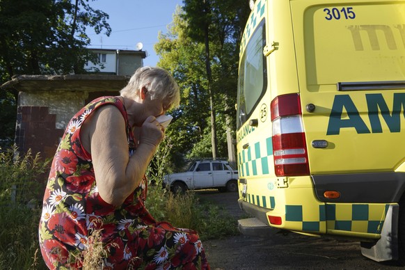 A woman cries after the body of her husband, who was killed in a yard of an apartment building during shelling, was loaded into an ambulance in Kharkiv, Ukraine, Monday, June 27, 2022. (AP Photo/Andri ...