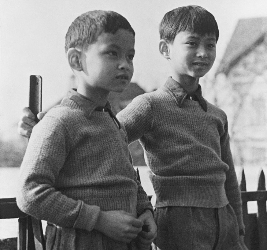 In this March 7, 1935, file photo, Prince Bhumibol, left, stands with his brother, King Ananda Mahidol of Siam, now known as Thailand, at their school in Lausanne Switzerland. Thailand&#039;s Royal Pa ...