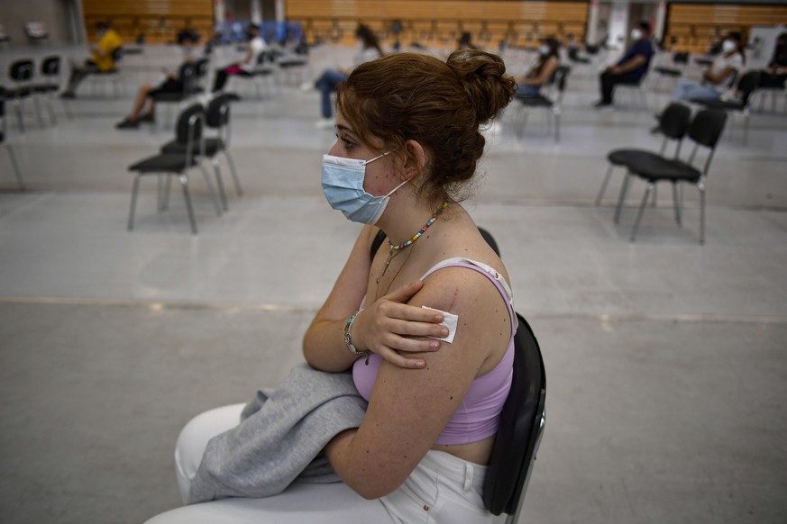 18 year old Idoia Casado waits after receiving the Pfizer COVID-19 vaccine during national COVID-19 vaccination campaign in Pamplona, northern Spain, Thursday, Sept. 2, 2021. Spanish authorities say m ...