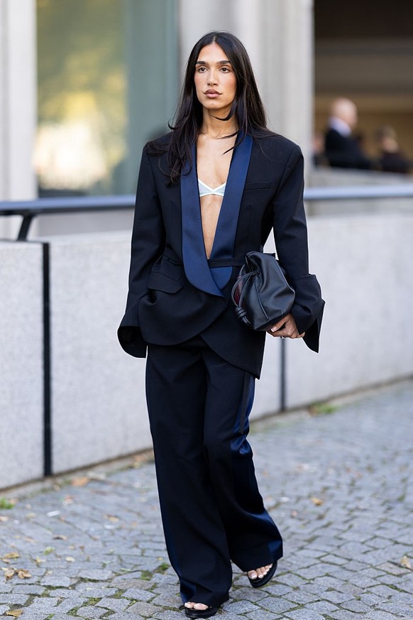 BERLIN, GERMANY - DECEMBER 10: Sonia Lyson is seen wearing black, oval-shaped Vehla sunglasses. Her outfit is cream-colored, consisting of a long, oversized faux fur coat that reaches her ankles. Unde ...