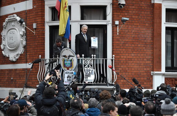 epa05144912 WikiLeaks founder Julian Assange (C) speaks to the media from a balcony of the Ecuadorian Embassy in London, Britain, 05 February 2016. Assange hailed a UN panel's finding that he is ...