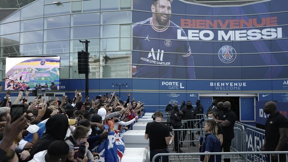 Paris Saint-Germain supporters gather outside the Parc des Princes stadium before Lionel Messi&#039;s press conference, Wednesday, Aug. 11, 2021 in Paris. Lionel Messi finally signed his eagerly antic ...