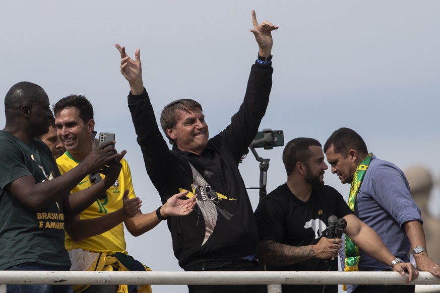 Brazil&#039;s President Jair Bolsoanro, center, gestures after a motorcycle tour with supporters in Rio de Janeiro, Brazil, Sunday, May 23, 2021. (AP Photo/Bruna Prado)