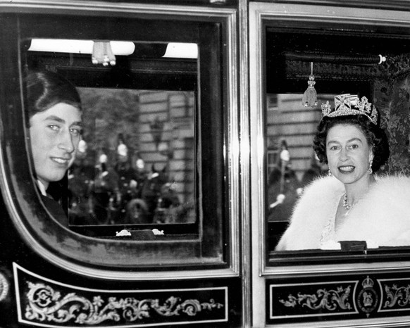 Queen Elizabeth II of England and her 18-year-old son Prince Charles, leave Buckingham Palace in a state coach, Oct. 31, 1967, for the opening of the Houses of Parliament. The prince was to take part  ...